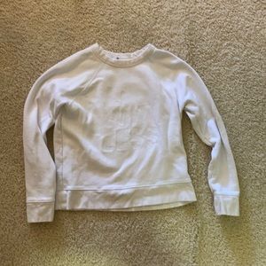 white athlete crew neck that says limit less. xs.